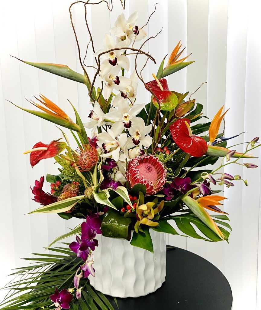 A vase filled with flowers is sitting on a table.