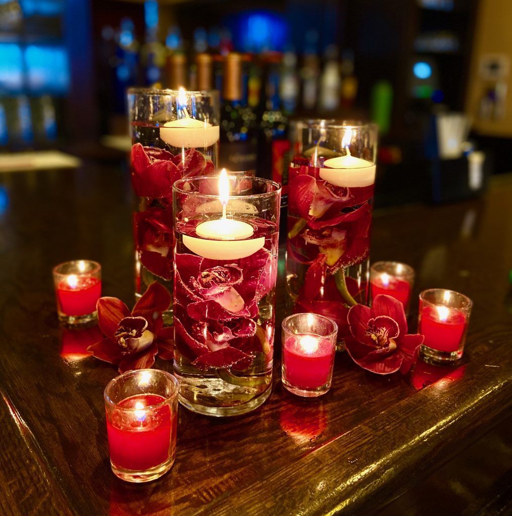 A table with candles and flowers on it