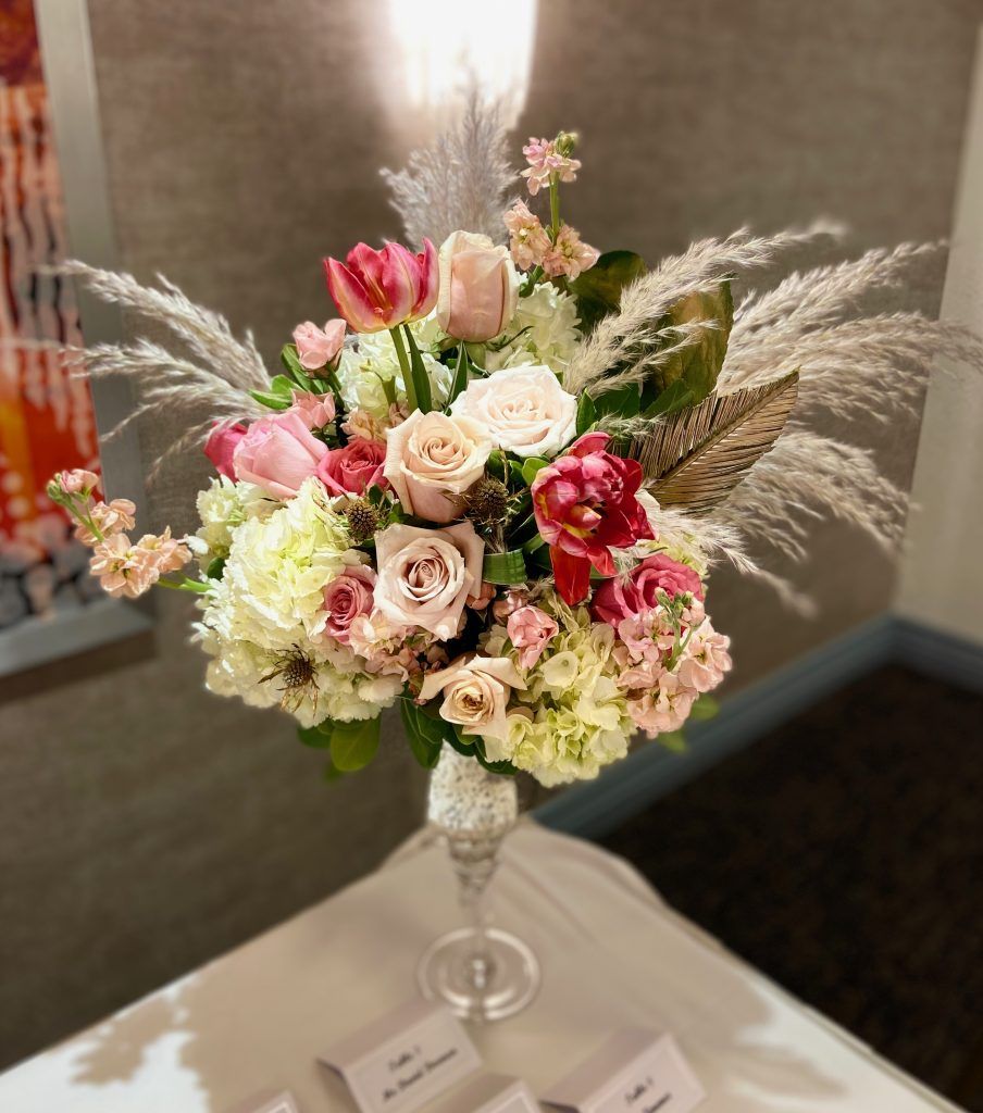 A vase filled with flowers is sitting on a table.