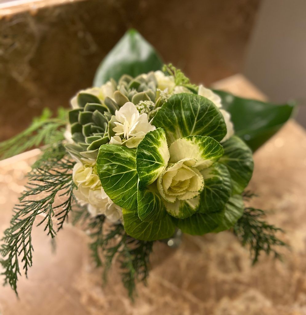 A close up of a bouquet of green and white flowers