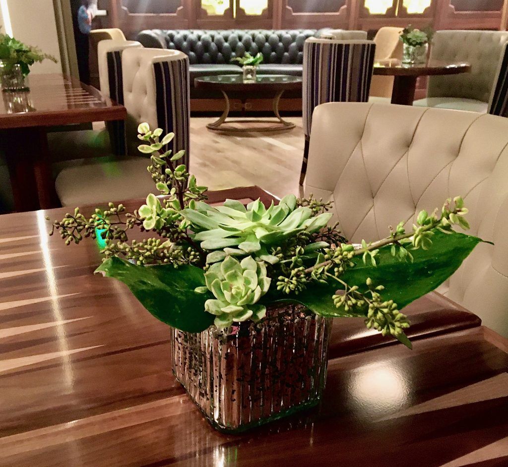 A table with a vase of flowers on it