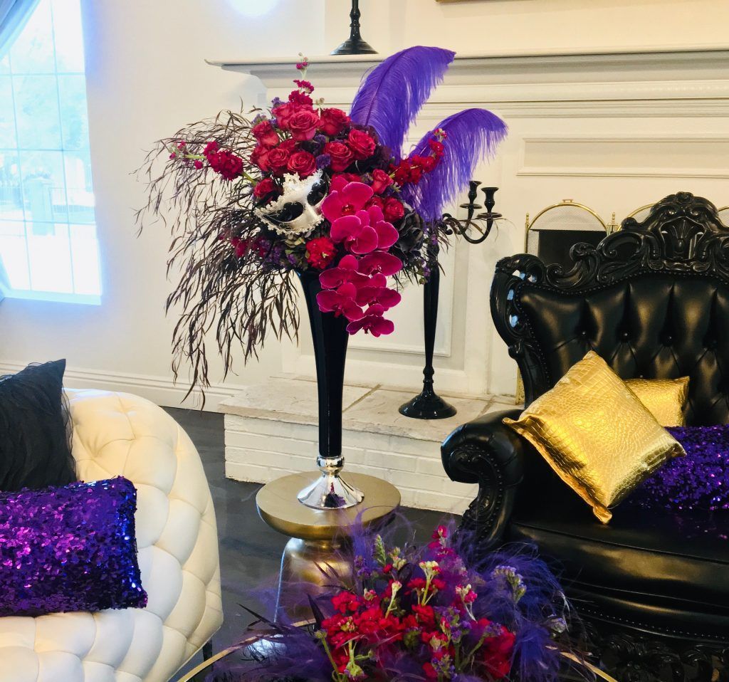 A living room filled with furniture and a vase of flowers