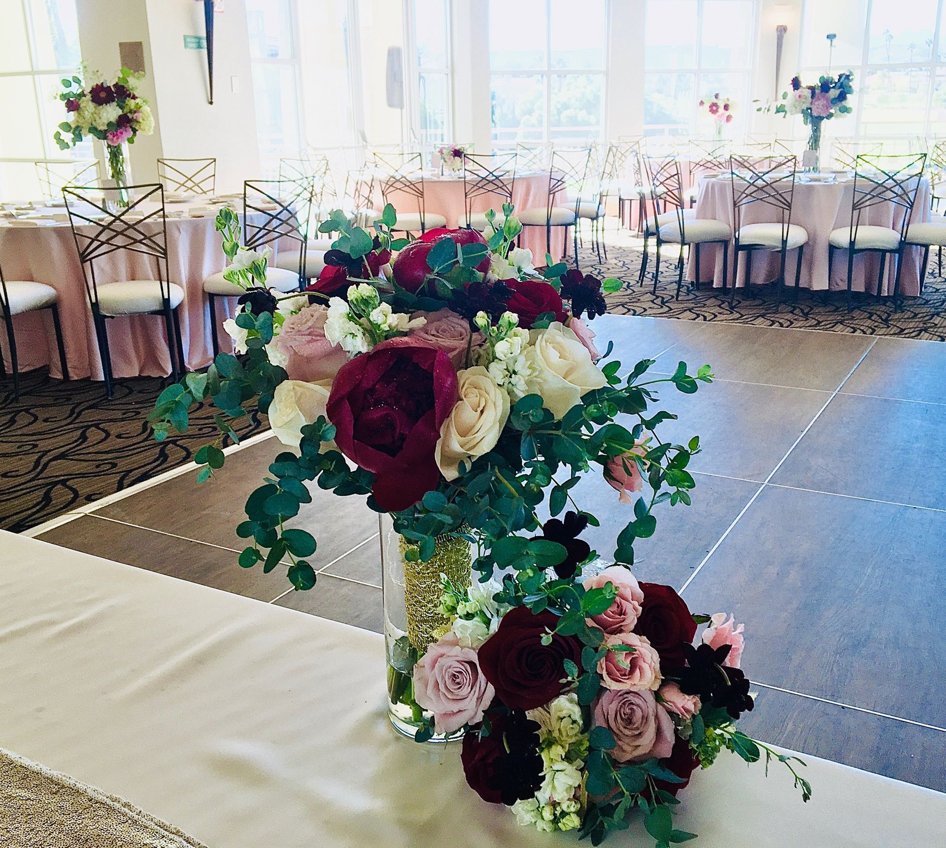 A vase filled with flowers sits on a table in a room