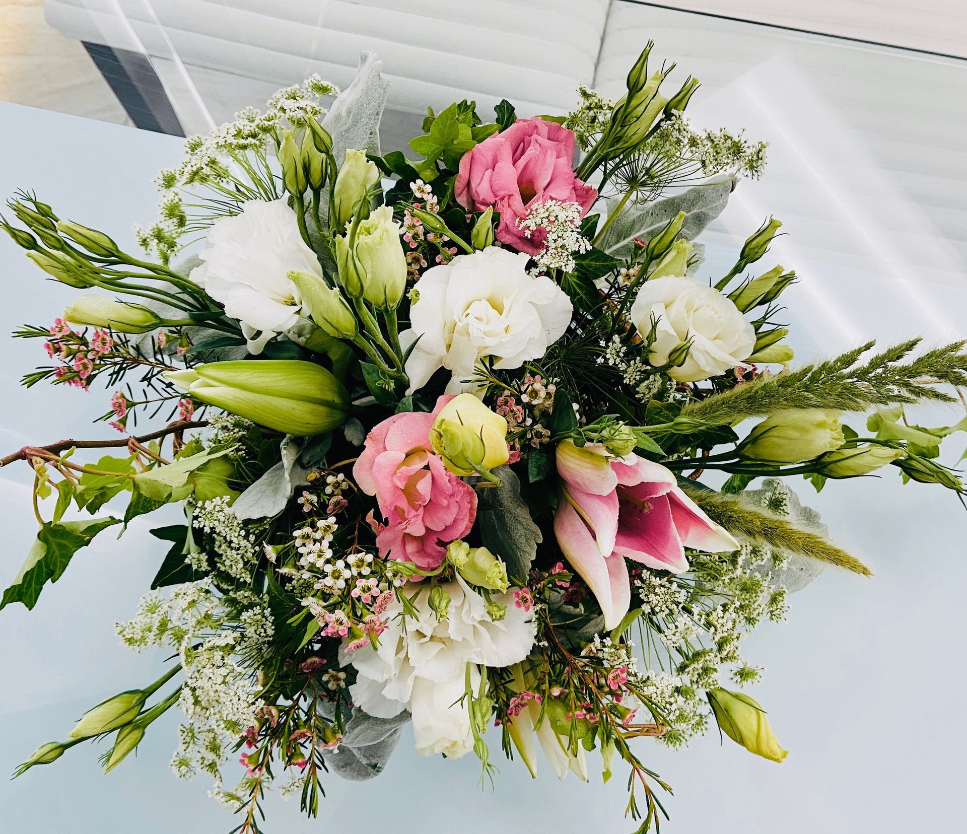 A bouquet of pink and white flowers on a table