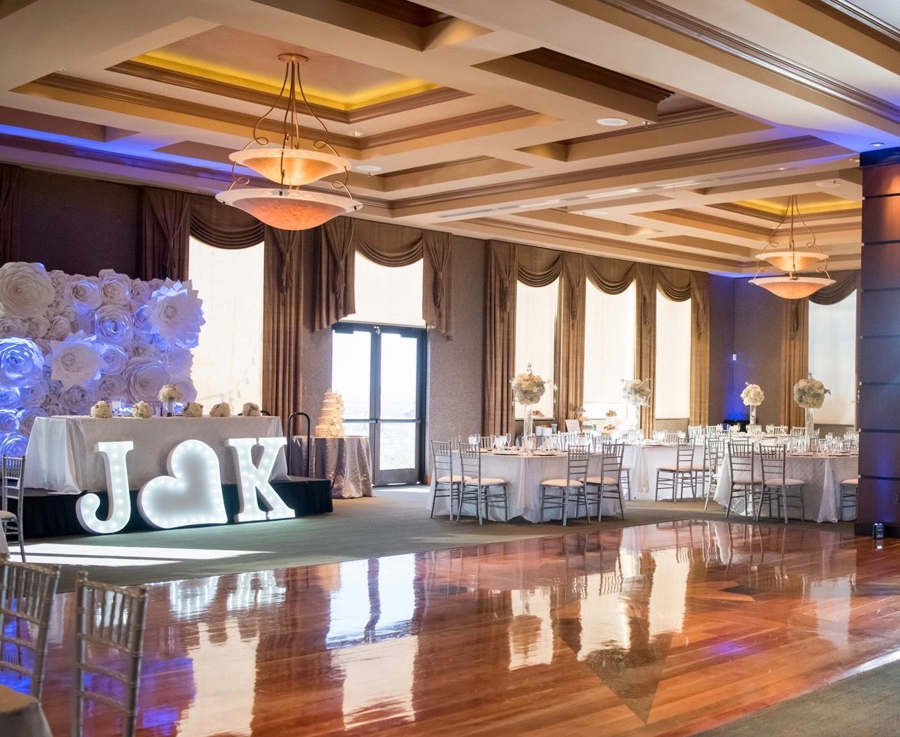 A large room with tables and chairs and a sign that says jak on the floor.