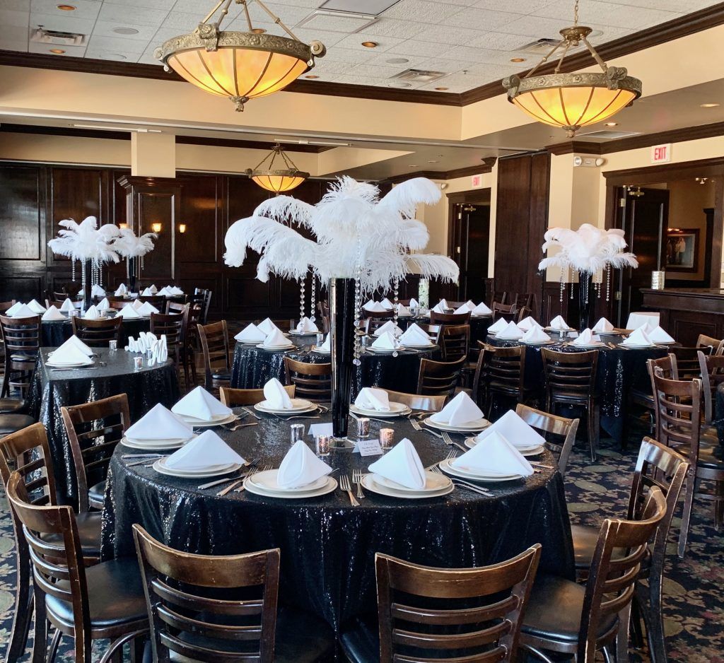 A large room with tables and chairs set up for a party.