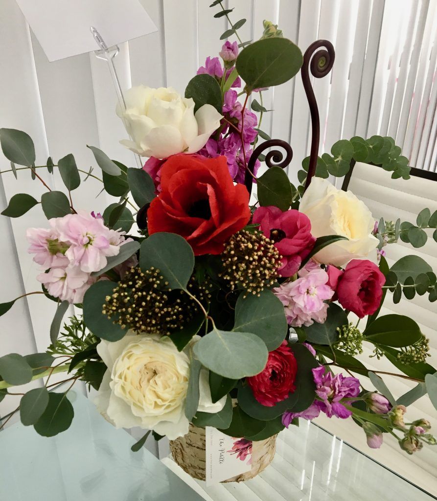 A vase filled with flowers is sitting on a table.