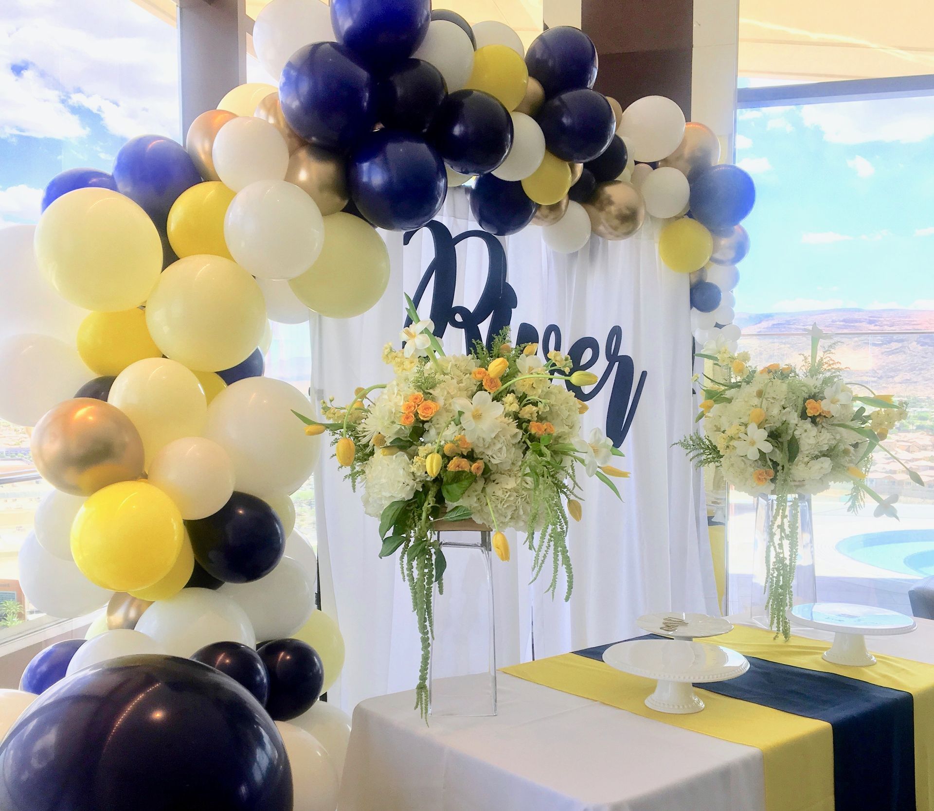 A room decorated with balloons and flowers and a sign that says peace