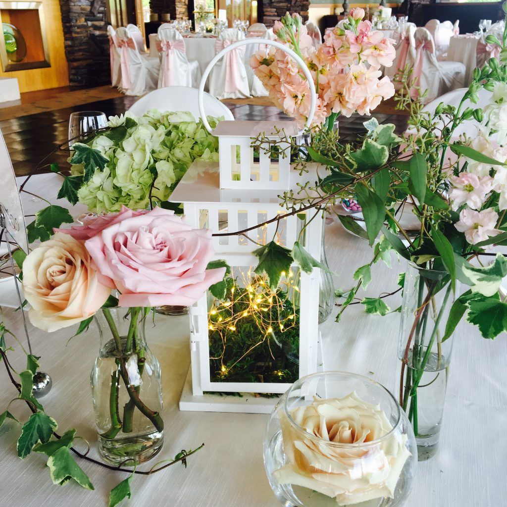 A table with flowers and lanterns on it