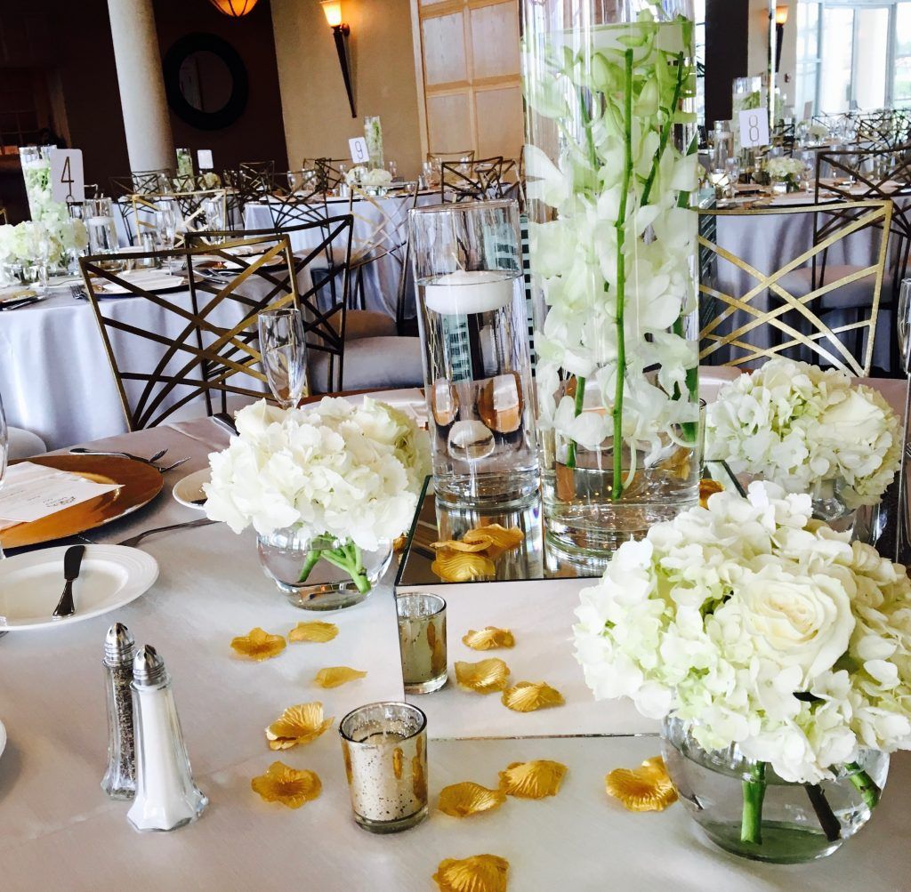 A table set for a wedding reception with flowers and candles