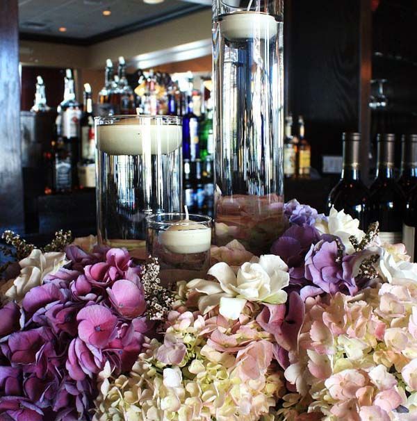 A bunch of flowers and candles on a table