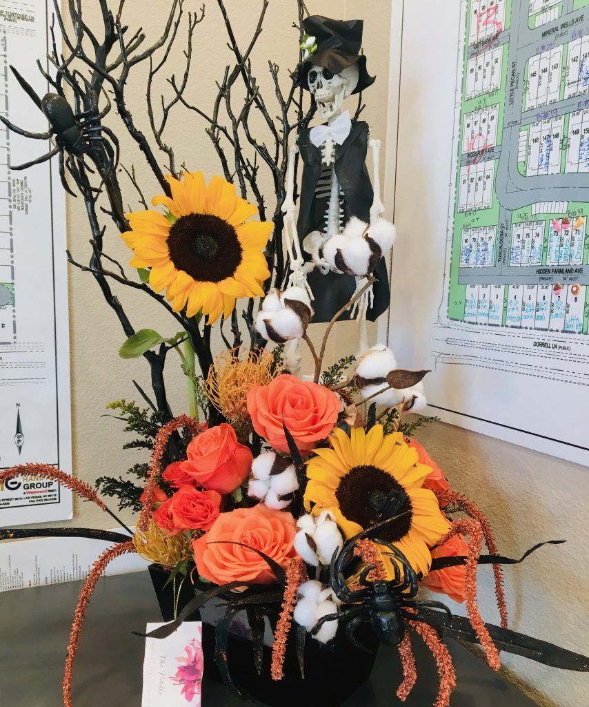 A bouquet of flowers with a skeleton in the background