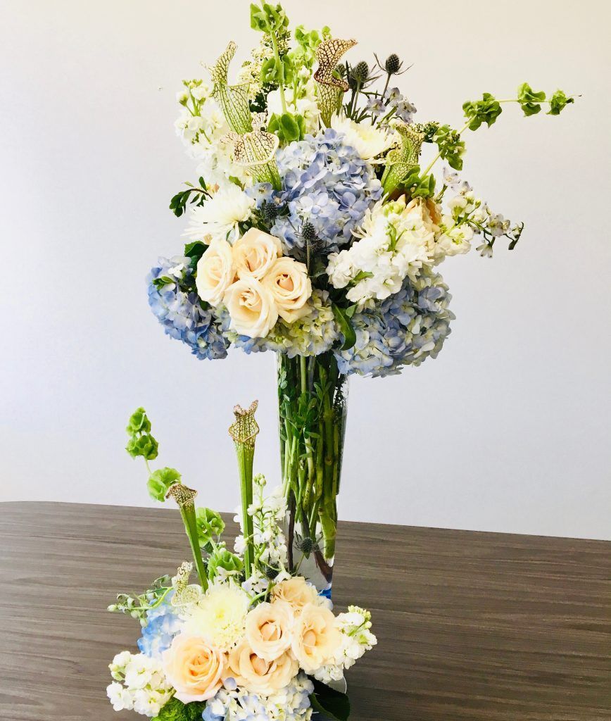 A vase filled with flowers is sitting on a table.