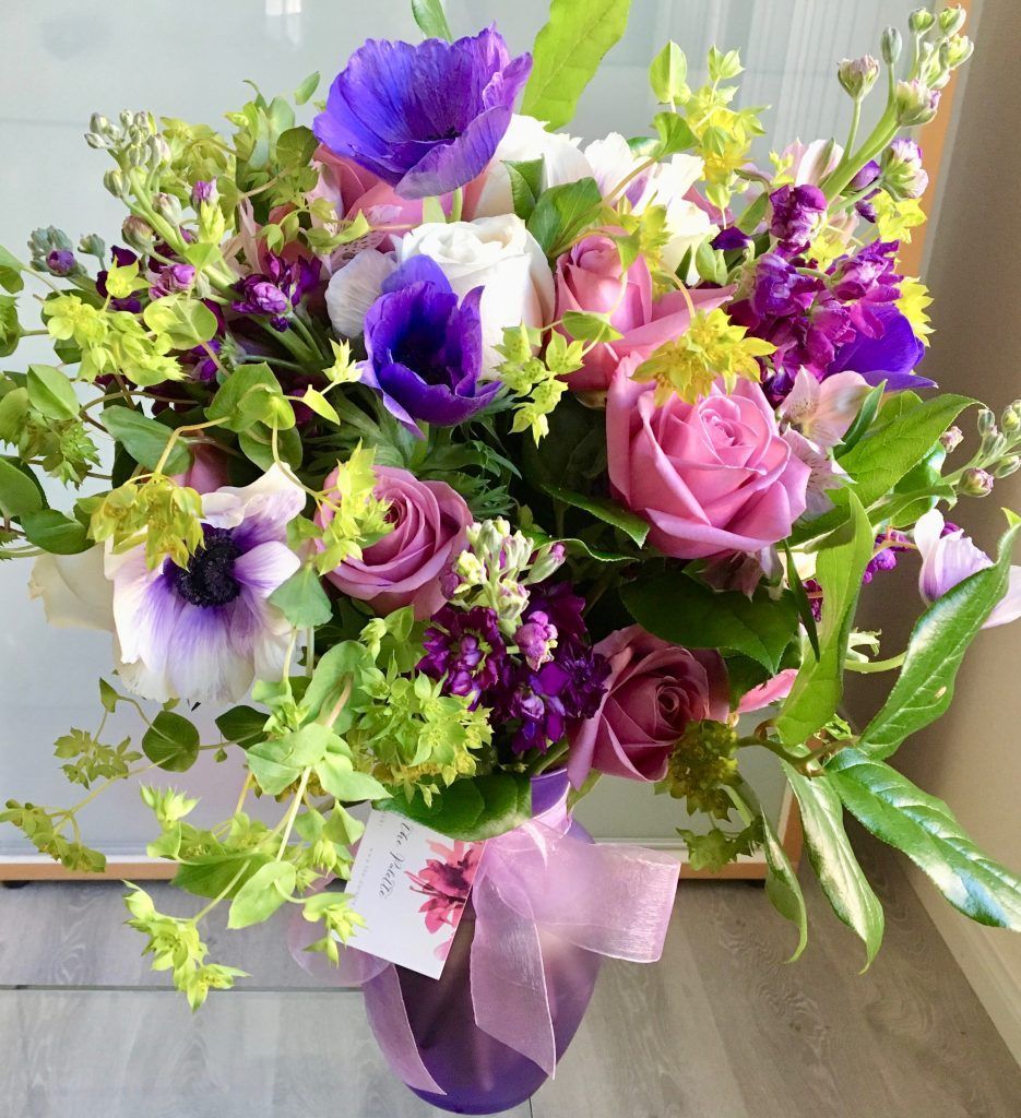 A vase filled with purple and pink flowers