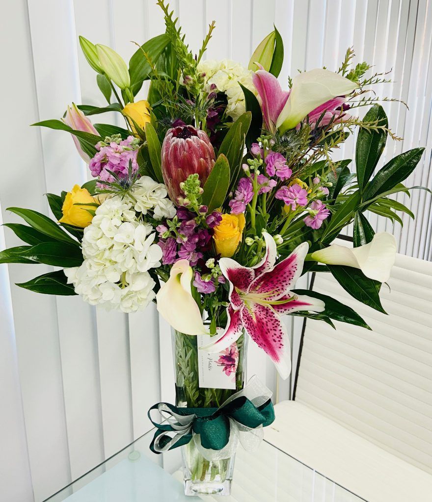 A vase filled with flowers is sitting on a table.