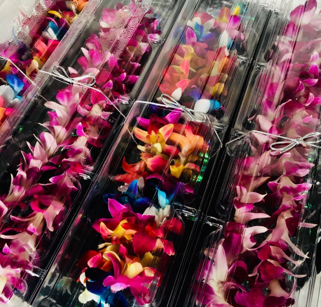 A bunch of flowers are wrapped in plastic and stacked on top of each other