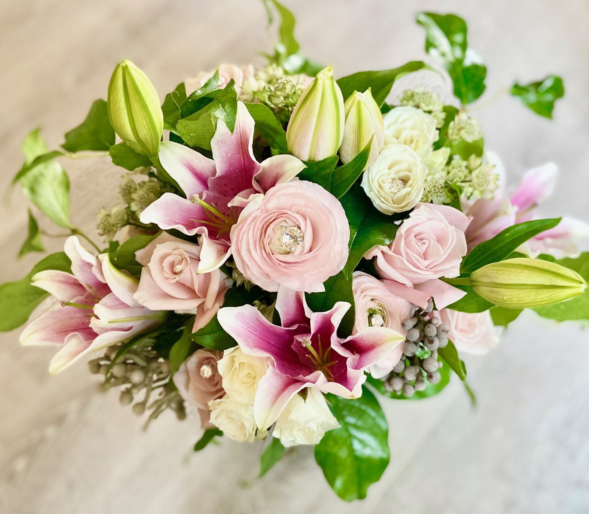 A bouquet of pink and white flowers is sitting on a table.