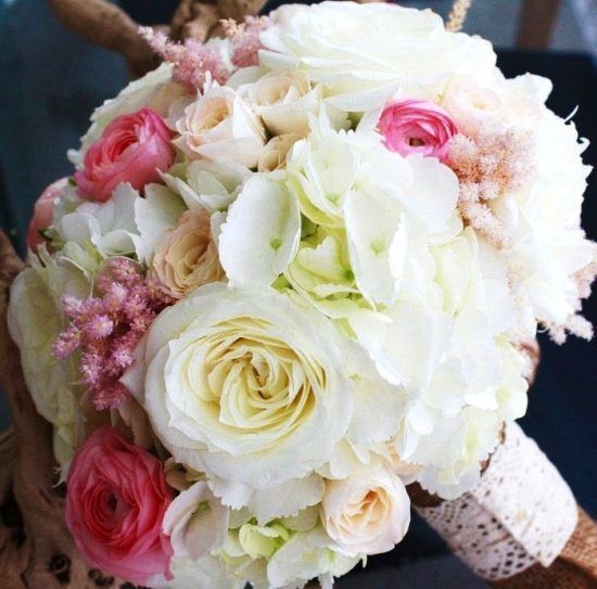 A close up of a bouquet of white and pink flowers