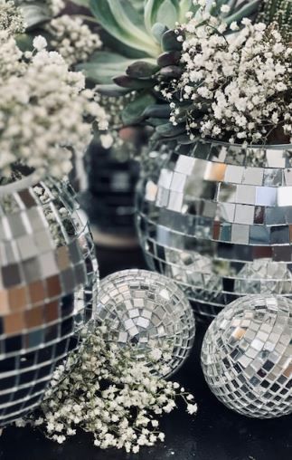 A group of disco balls sitting next to each other on a table.
