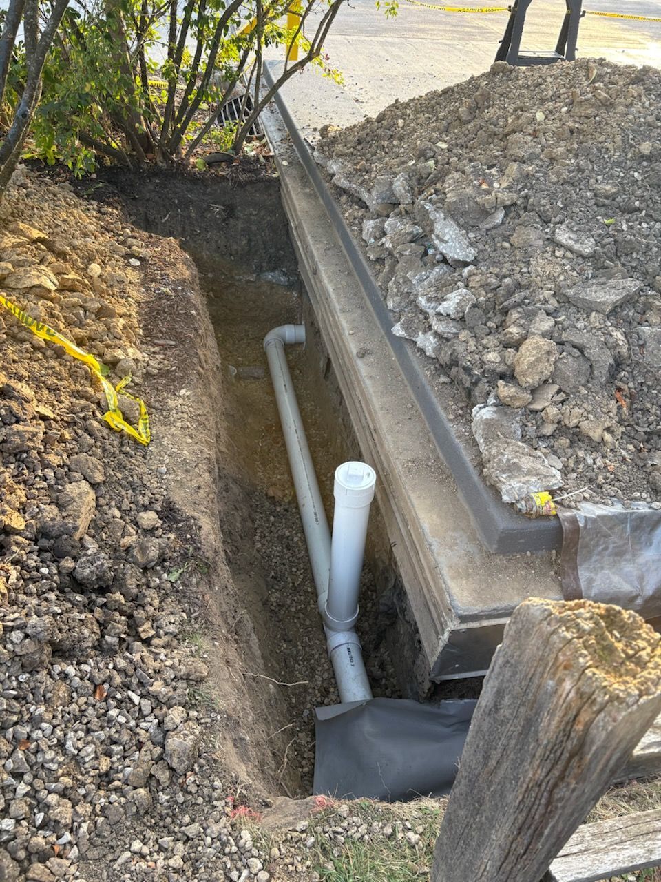 A person holding a baby up in the air indoors near a window, baby smiling.