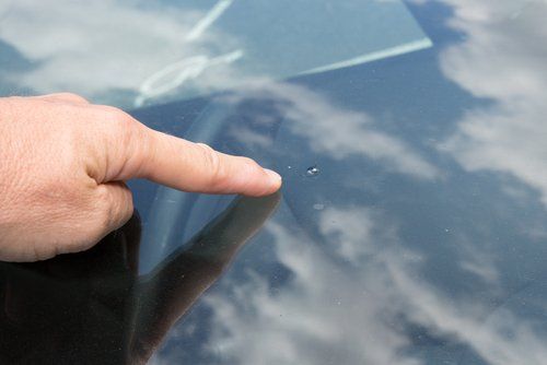 Finger Pointing at Chip in Windscreen — Windscreens in Bathurst, NSW
