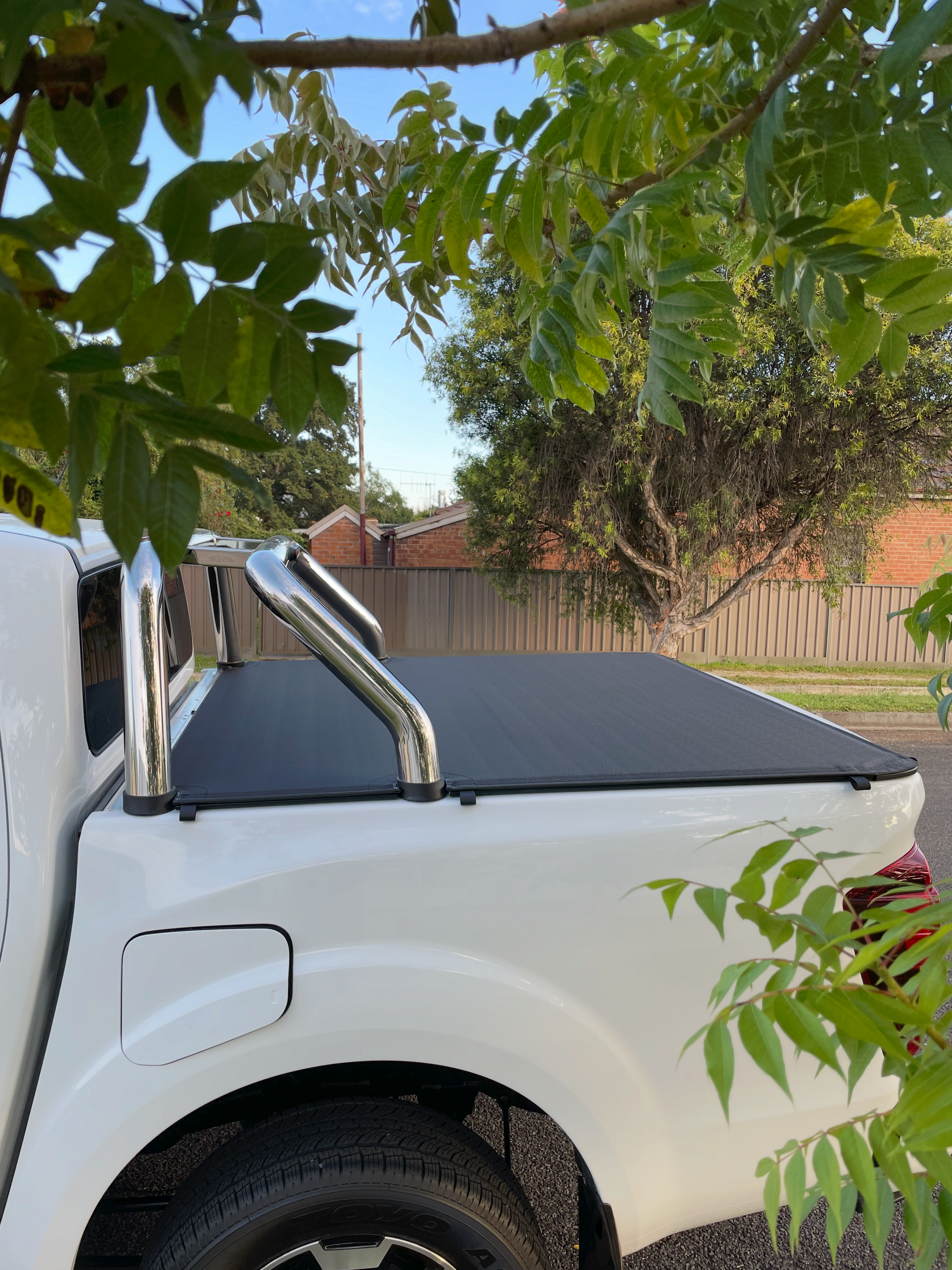 A White Ute On A Road With A Black Canopy Cover— Simmons Glass & Trim In Bathurst, NSW