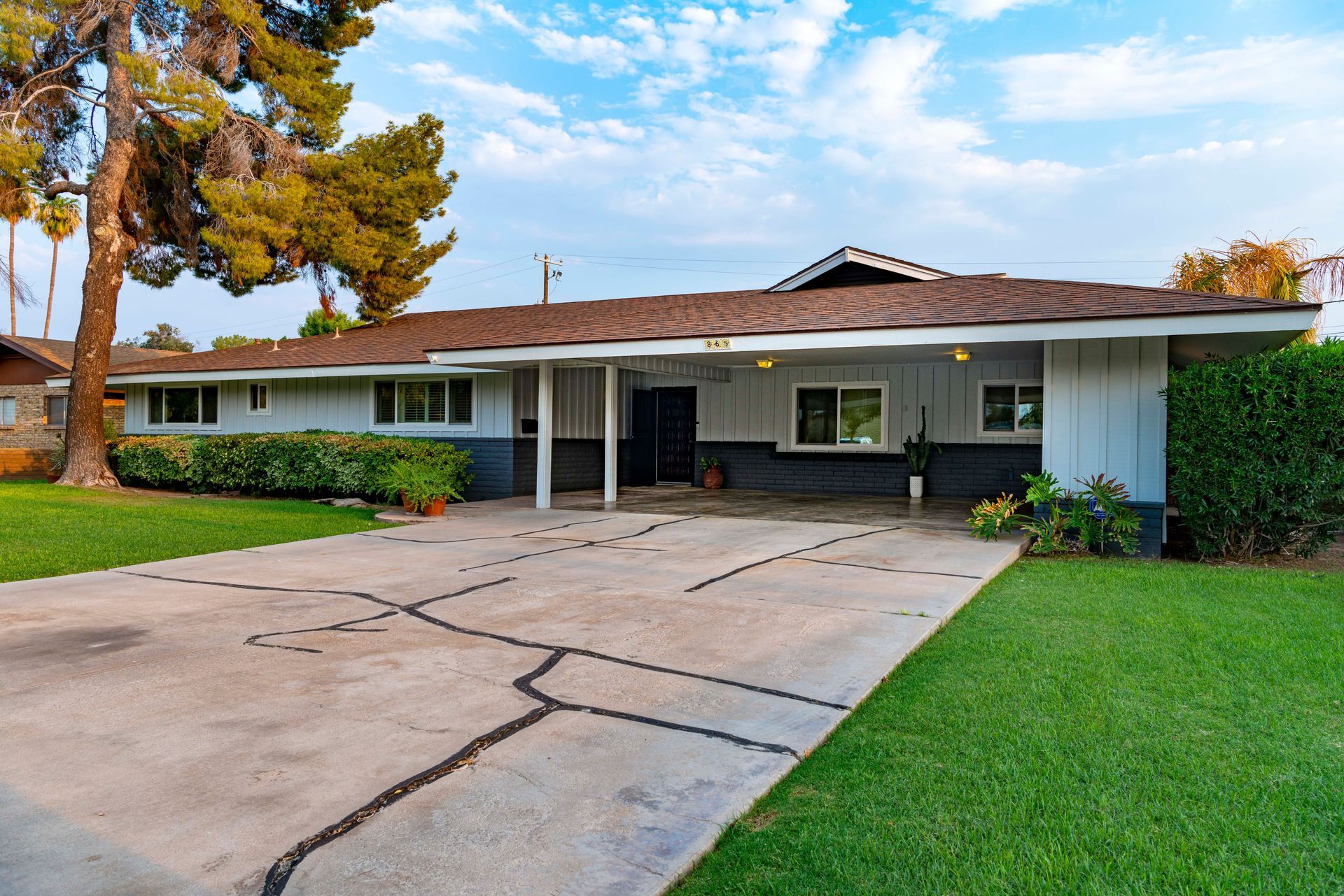 Arizona ranch home with green lawn in a Goodyear AZ suburban neighborhood