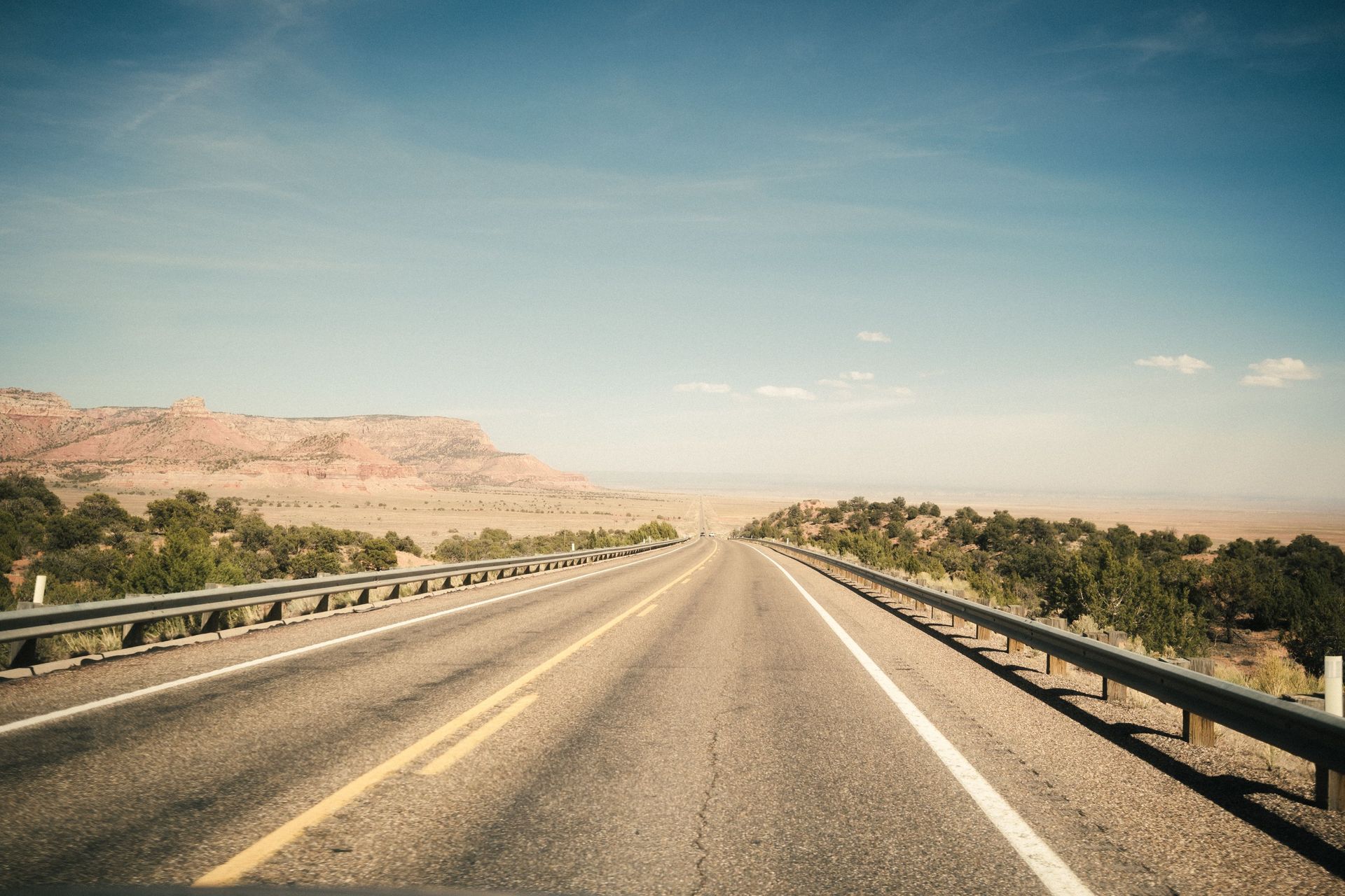 Empty desert highway in Arizona representing the road to affordable car insurance