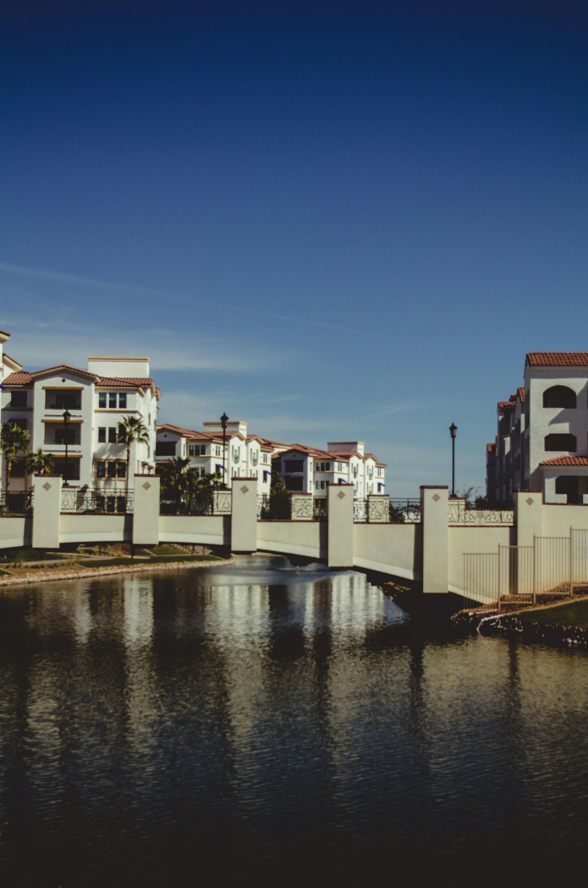 Luxury Mediterranean-style apartment complex in Scottsdale, Arizona with palm trees and clear blue sky