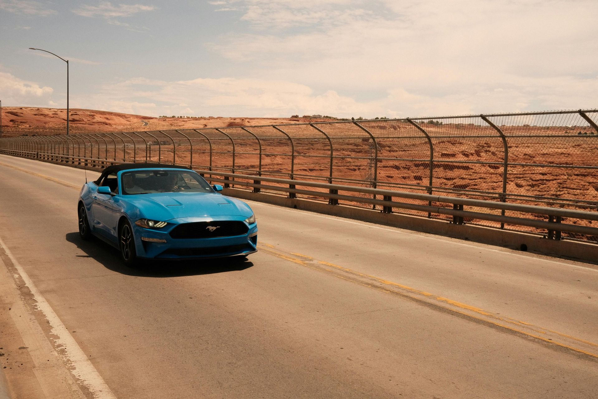 Blue sports car on an open Arizona desert road, representing car insurance for Scottsdale drivers