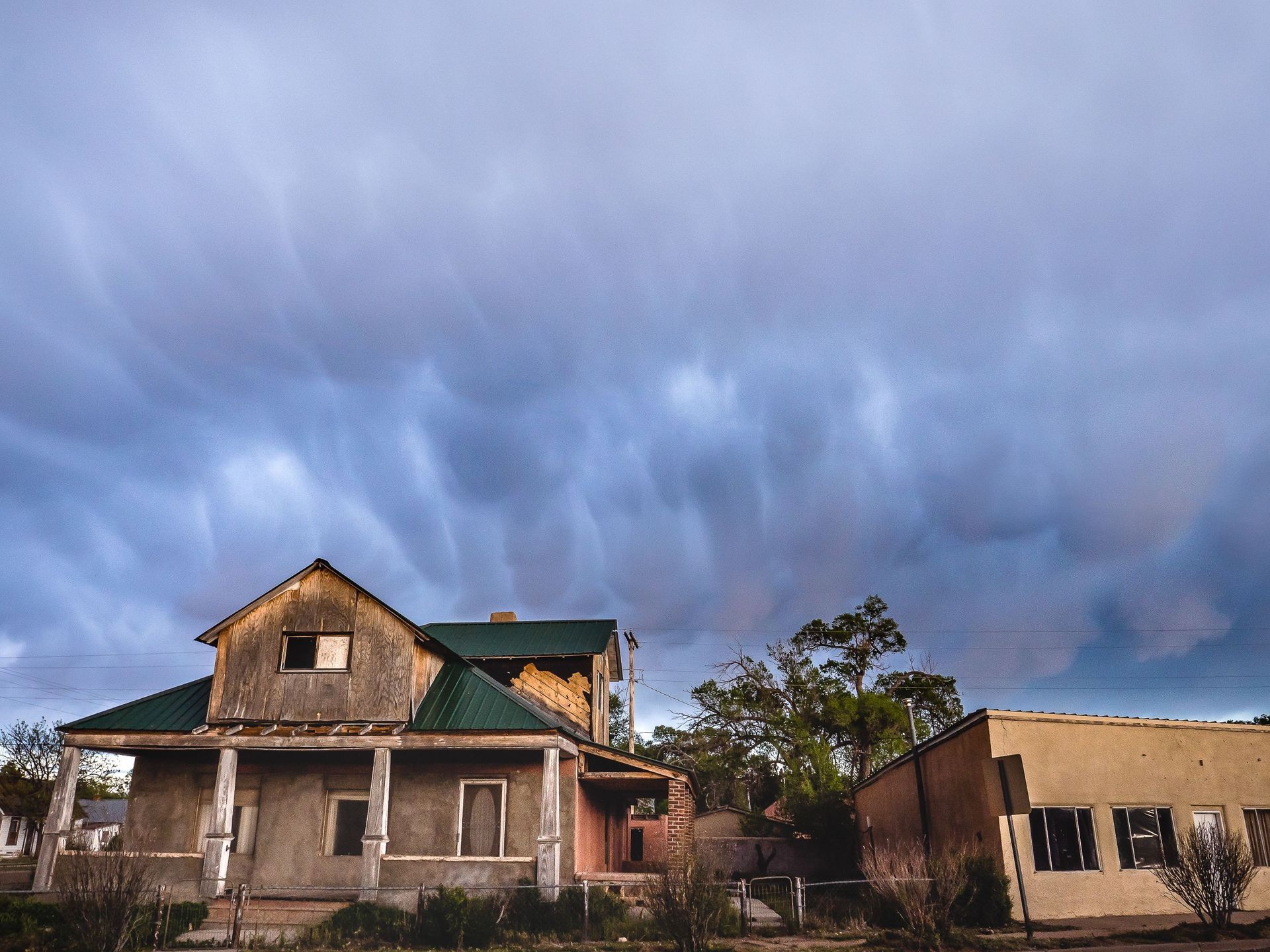Storm clouds over an Arizona home needing water backup coverage for sewer and drain backups
