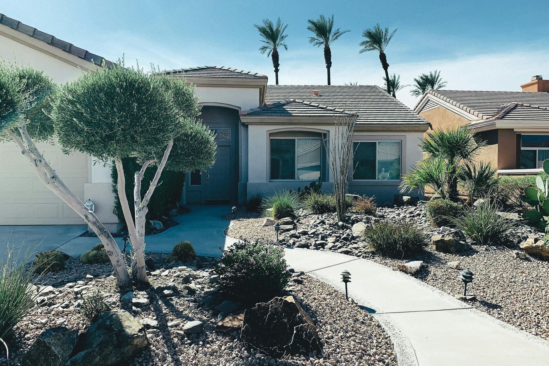 Single-story Gilbert AZ stucco home with desert landscaping representing East Valley homeowners insu