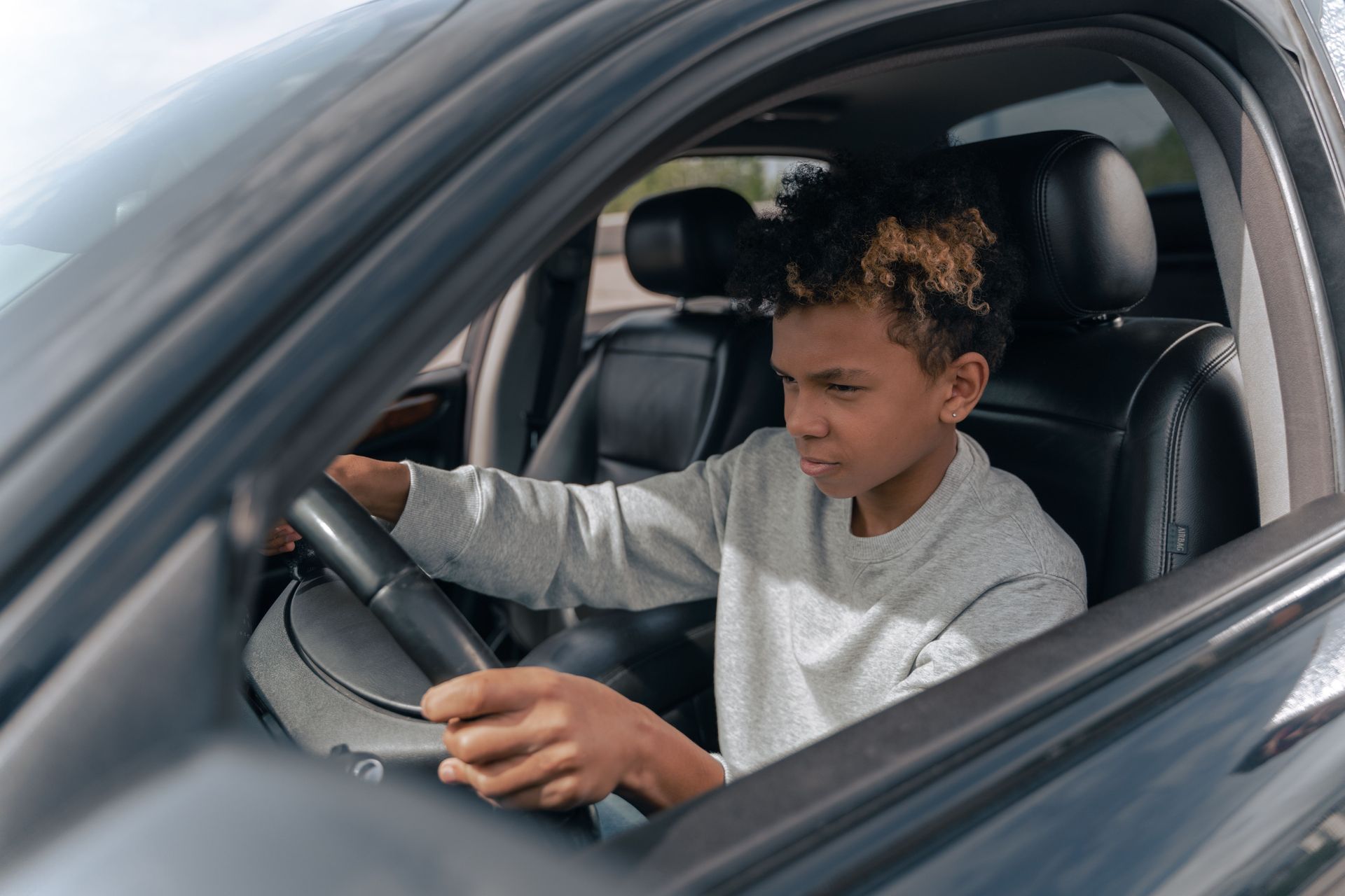 Young Gilbert Arizona driver behind the wheel, illustrating local car insurance coverage