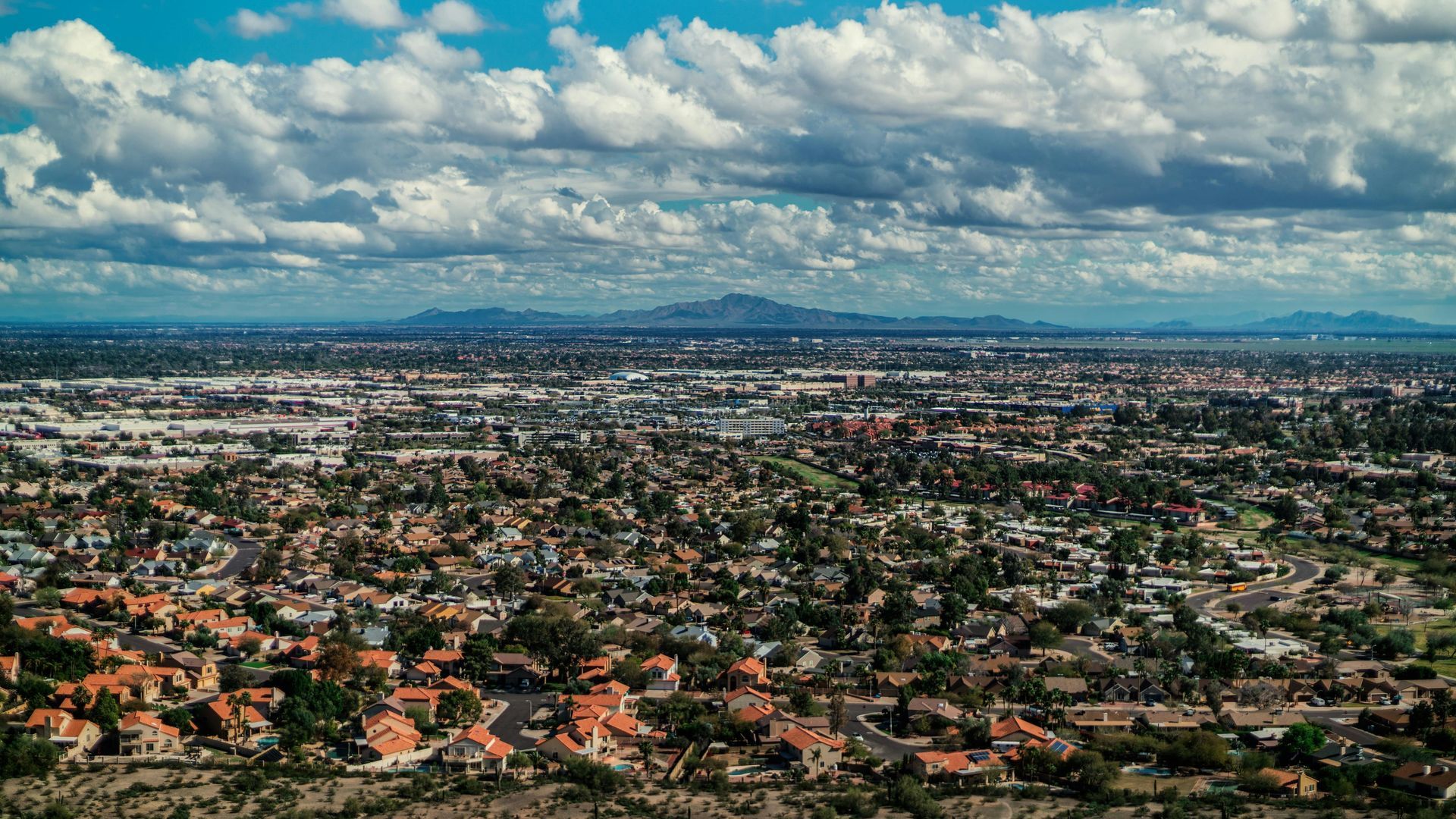 Aerial view of Peoria, Arizona residential neighborhoods, showing West Valley suburban homes and mou