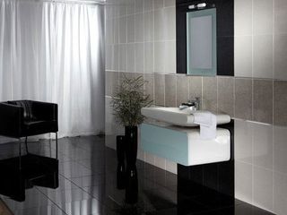 modern bathroom with sink and tile wall