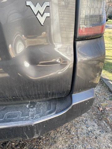 A close up of the back bumper of a gray truck.