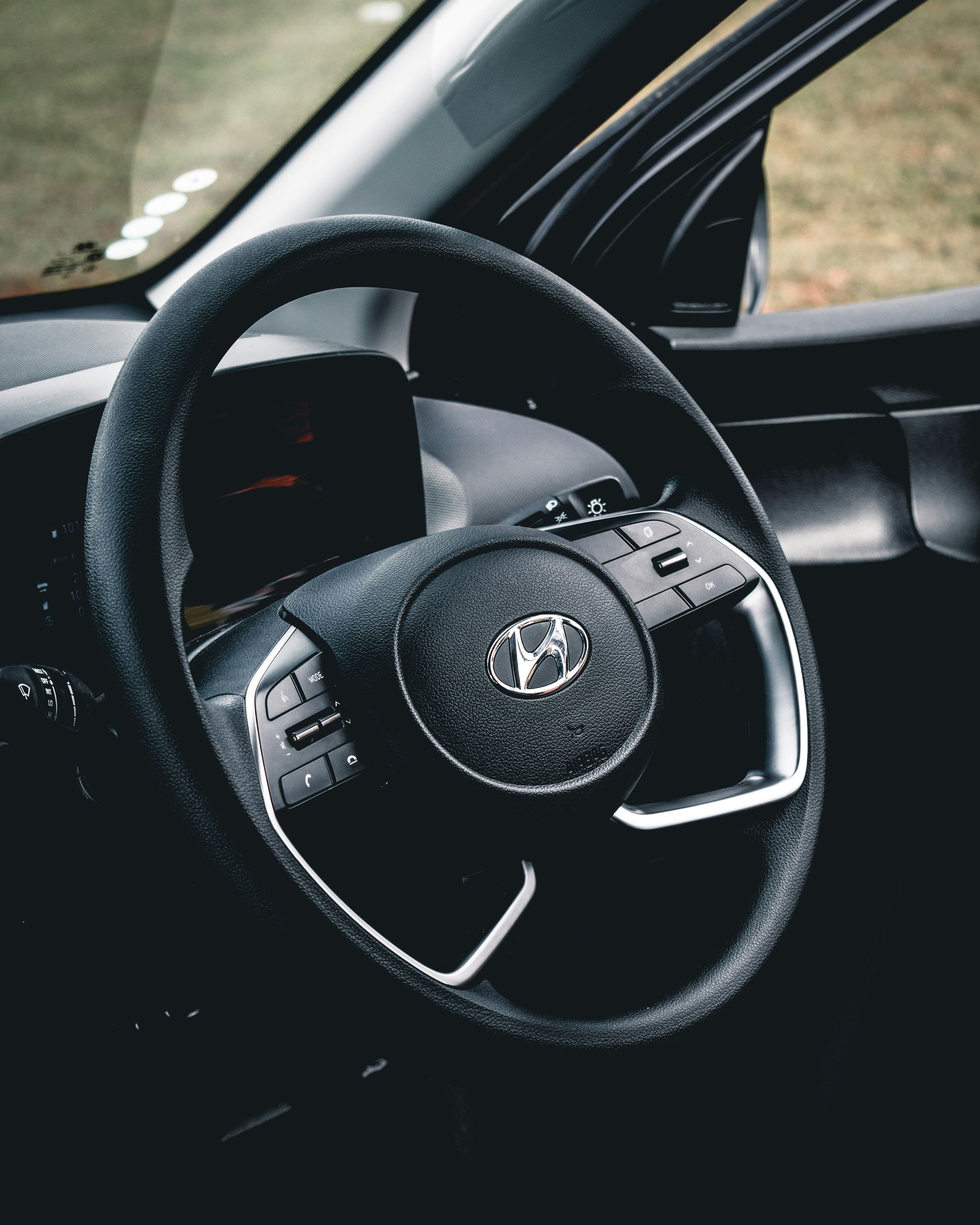 Black steering wheel of a Hyundai car.
