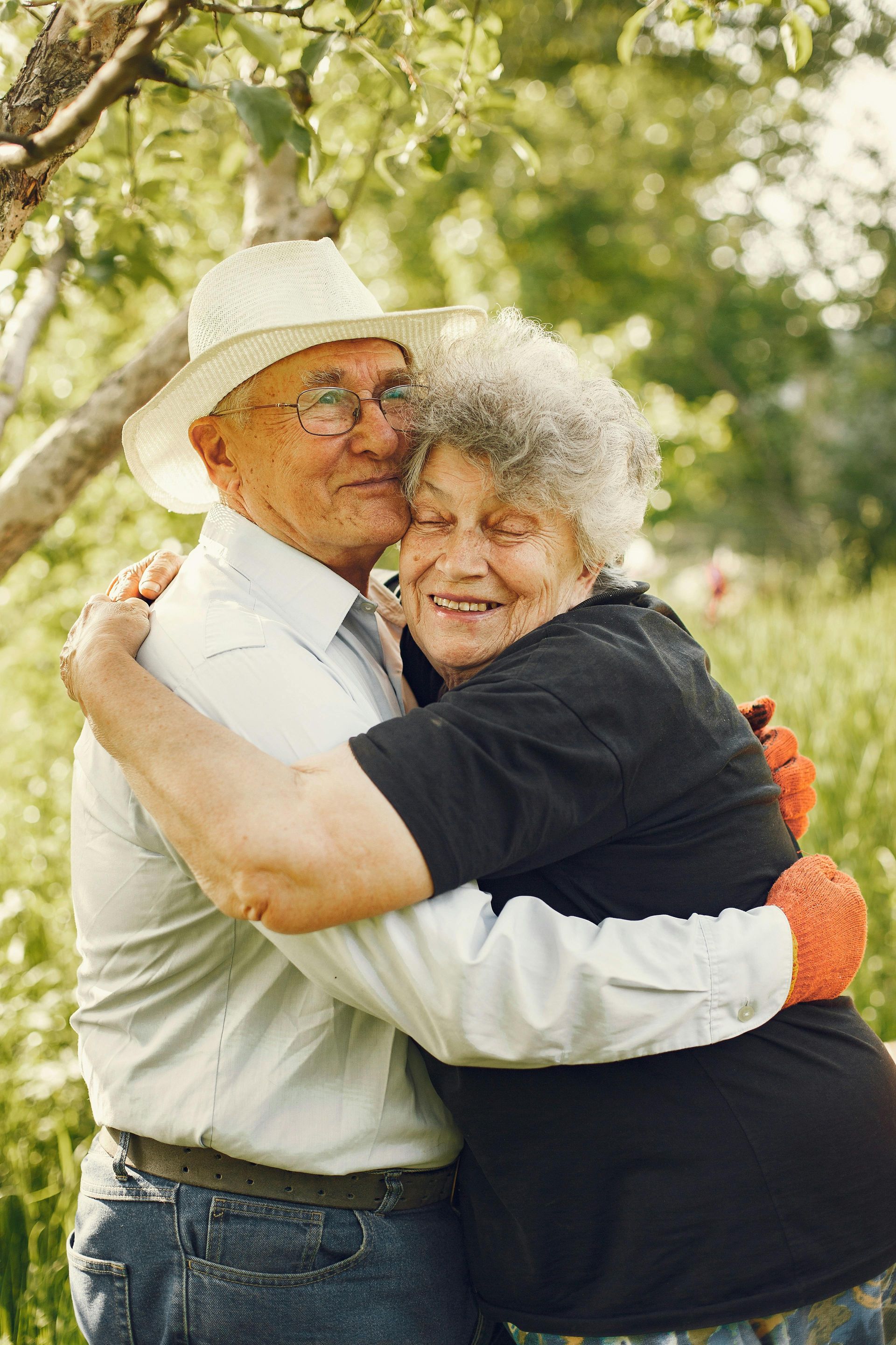 A woman is standing in the snow holding skis.