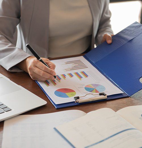 Business Women Reviewing Data in Financial Statement — Battle Creek, MI — Best Investing & Tax