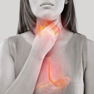 Woman experiencing acid reflux — Wyoming, MI — Dental South