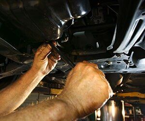 Hands of Mechanic Working Under Car - Engine Filters in Bellflower, CA