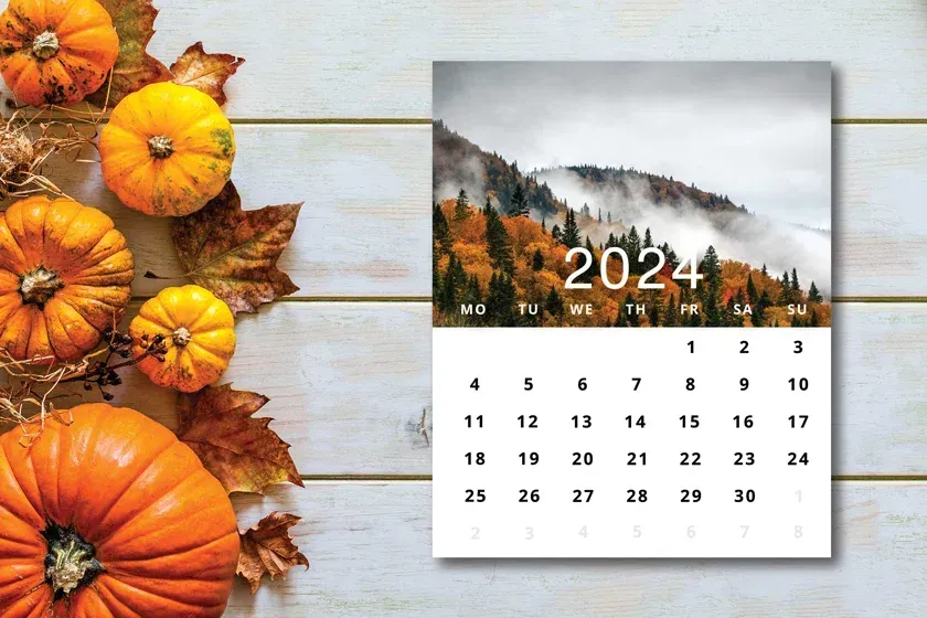 A calendar with flowers on a wooden table