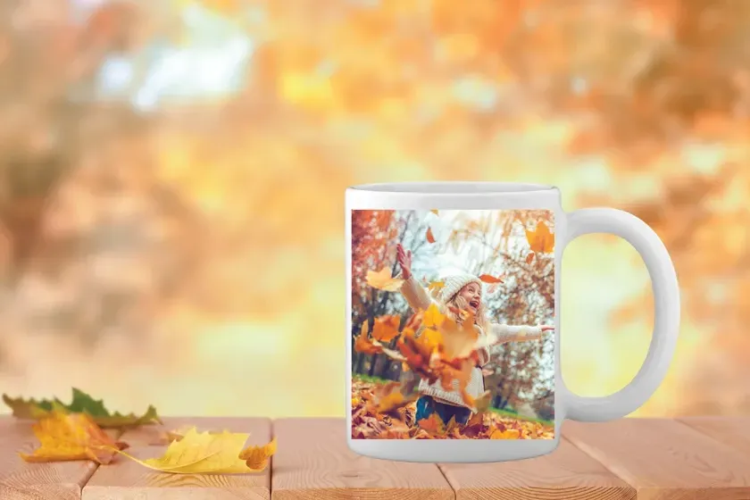 A white coffee mug with a picture of a man and a woman on it