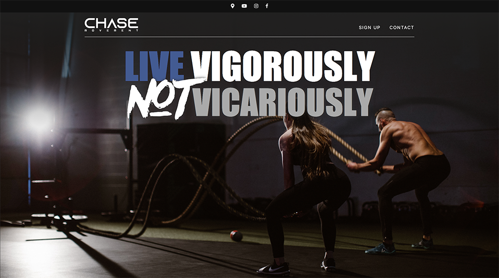 A man and a woman are squatting down with ropes in a gym.
