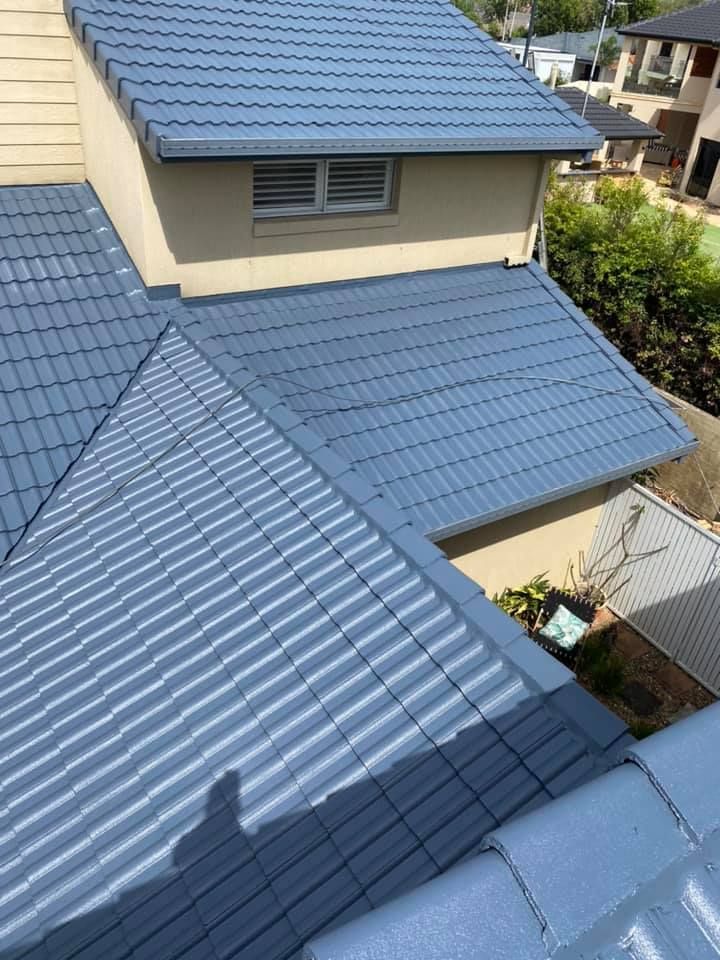 Blue Tiled Roof of A Two-Story Building — SEQ Roof Repaints In Bonogin, QLD
