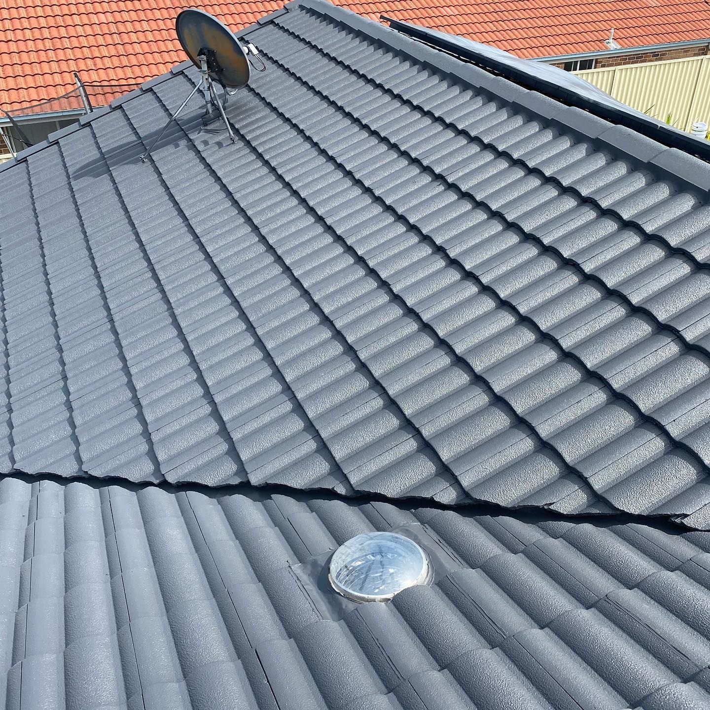 Gray Metal Roof with Ribbed Texture, a Satellite Dish, and A Skylight — SEQ Roof Repaints In Logan, QLD
