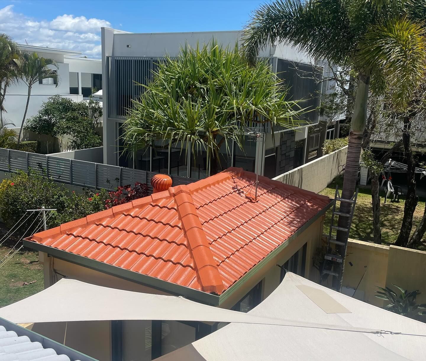 Orange-Tiled Roof of A Building, with Trees — SEQ Roof Repaints In Tweed Heads, QLD