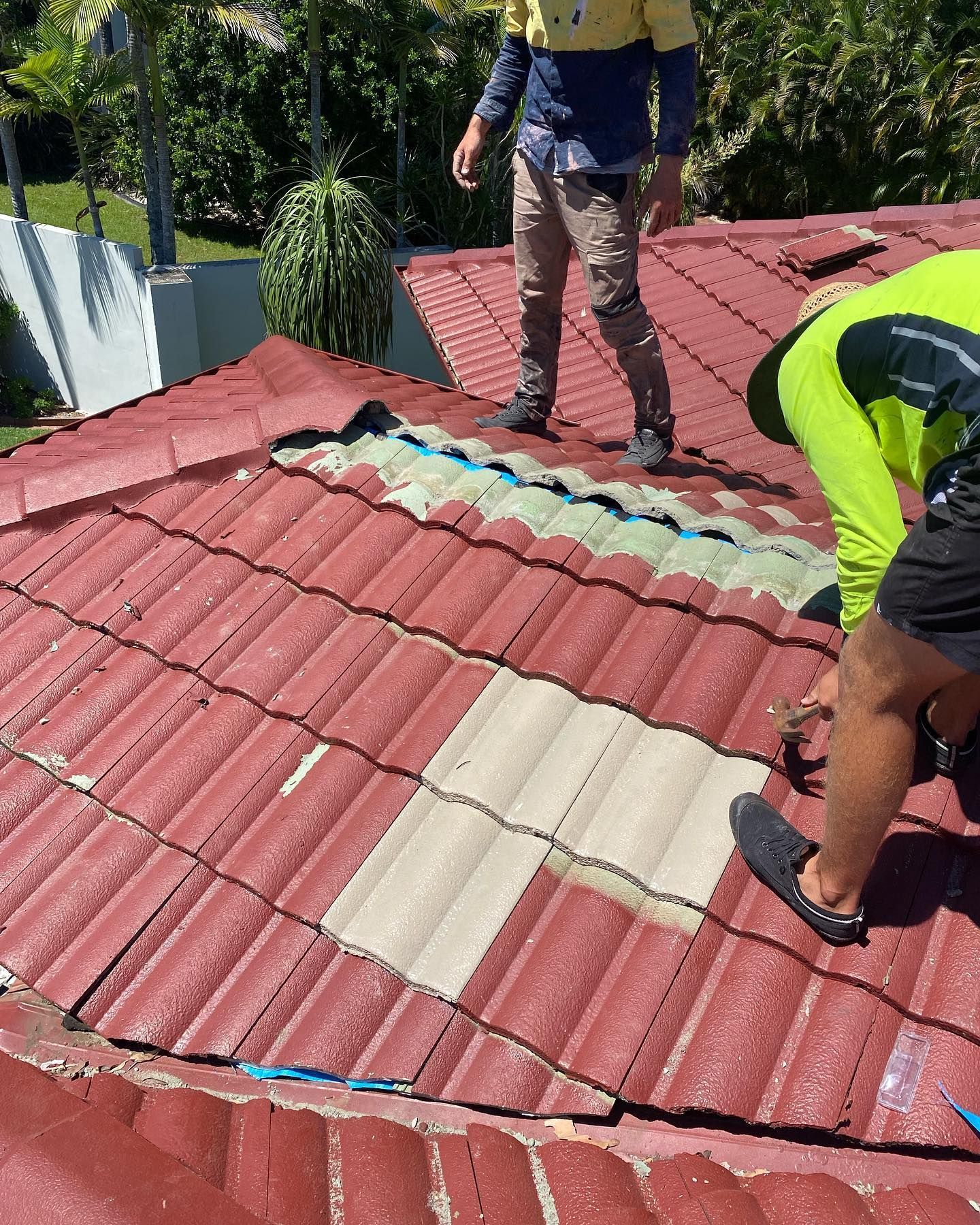 Two Workers on A Red Tiled Roof, Replacing Cream-Colored Tiles — SEQ Roof Repaints In Bonogin, QLD