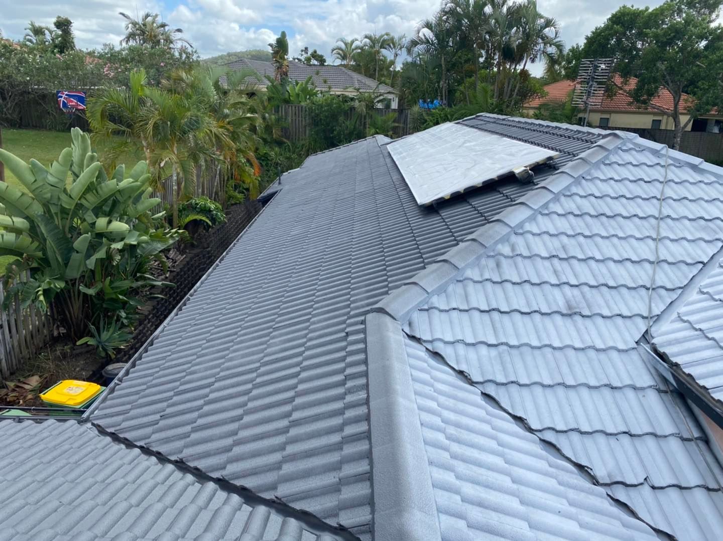 Gray Tiled Roof With Sections of Darker Gray and a Light-colored Panel — SEQ Roofing & Painting in Nerang, QLD