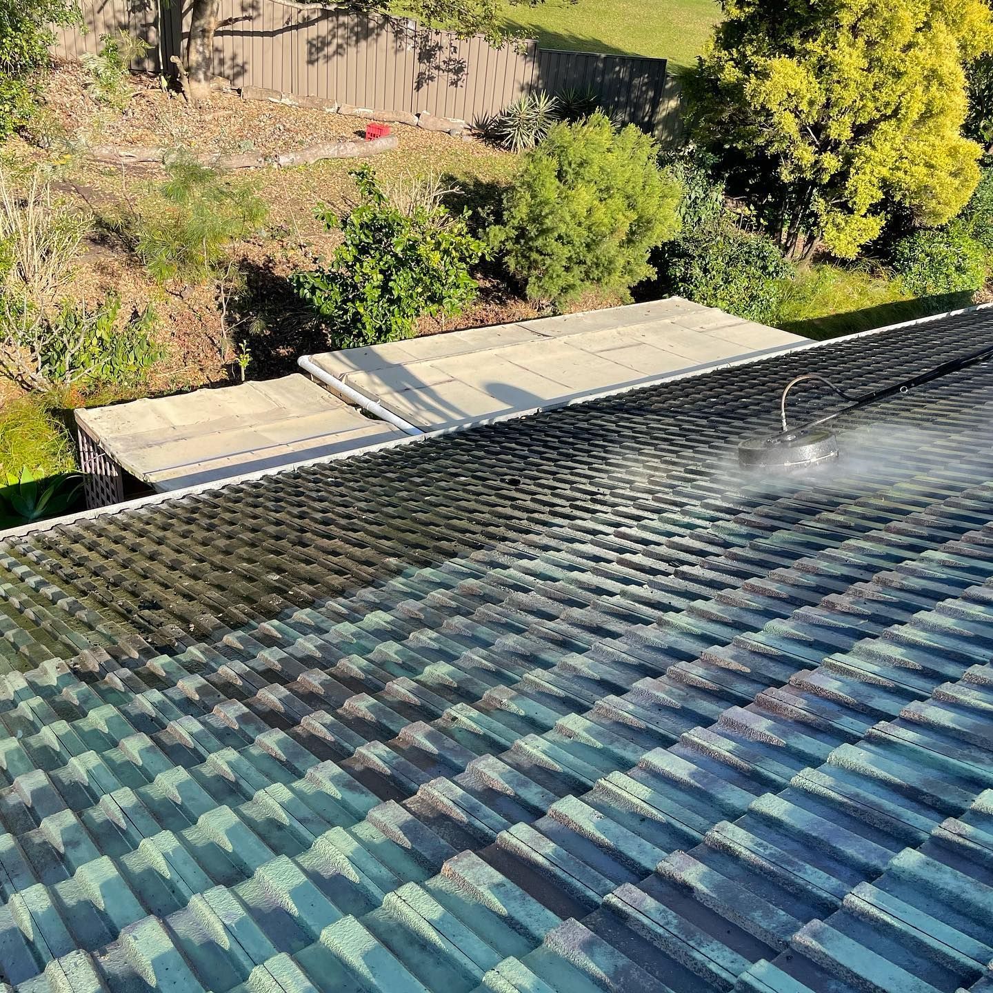 Washing a Roof, Water Spray Creates a Clean Section, Showing the Difference — SEQ Roofing & Painting in Surfers Paradise, QLD